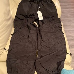 Woman’s black cargo parachute pants. Size M